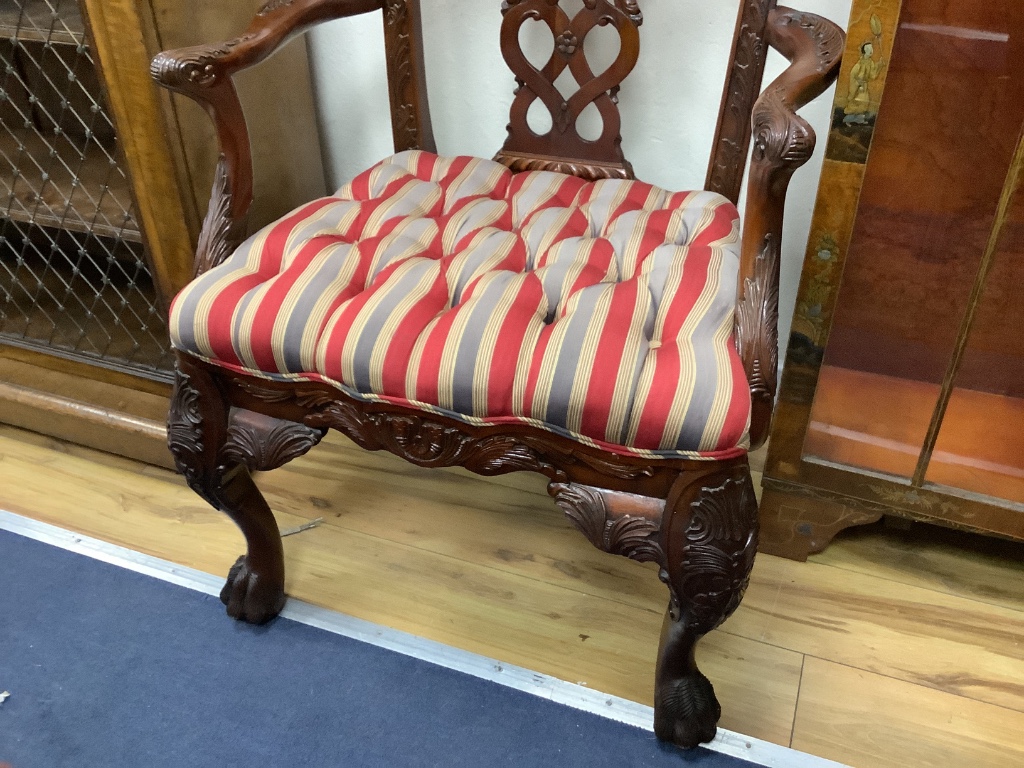 A pair of George III style Irish design mahogany elbow chairs